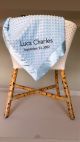 Personalized Minky Dot baby blanket in light blue with a silky satin border, embroidered with name and birth date available in multiple colors and sizes.Minky Dot Light Blue Font: Gil Sans MT Thread Color: Charcoal 