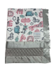A jungle animal-themed print featuring giraffes, lions, elephants, and zebras in pink and blue. It has a soft silver satin trim.
