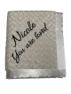 Personalized ivory luxe rose baby receiving blanket with embroidered text "Nicole You are loved" in cursive, soft plush fabric.