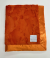 Luxe Bella orange security baby blanket with plush minky fabric and soft satin border, perfect for soothing and comforting babies.

