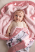 Adorable baby girl wrapped in a soft pink satin-trimmed blanket, featuring a cozy plush interior and a llama-print minky fabric exterior. Perfect for newborn comfort, snuggles, and personalized gifting."