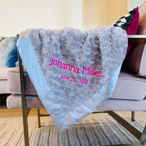 Blue fuzzy blanket on the arm of a chair