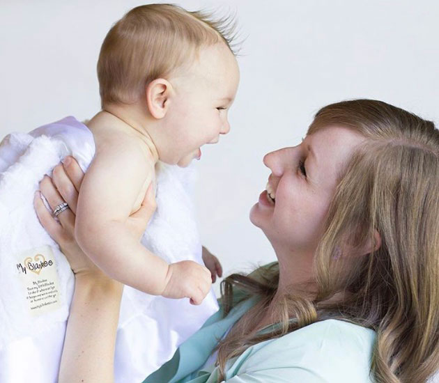 Woman holding laughing baby